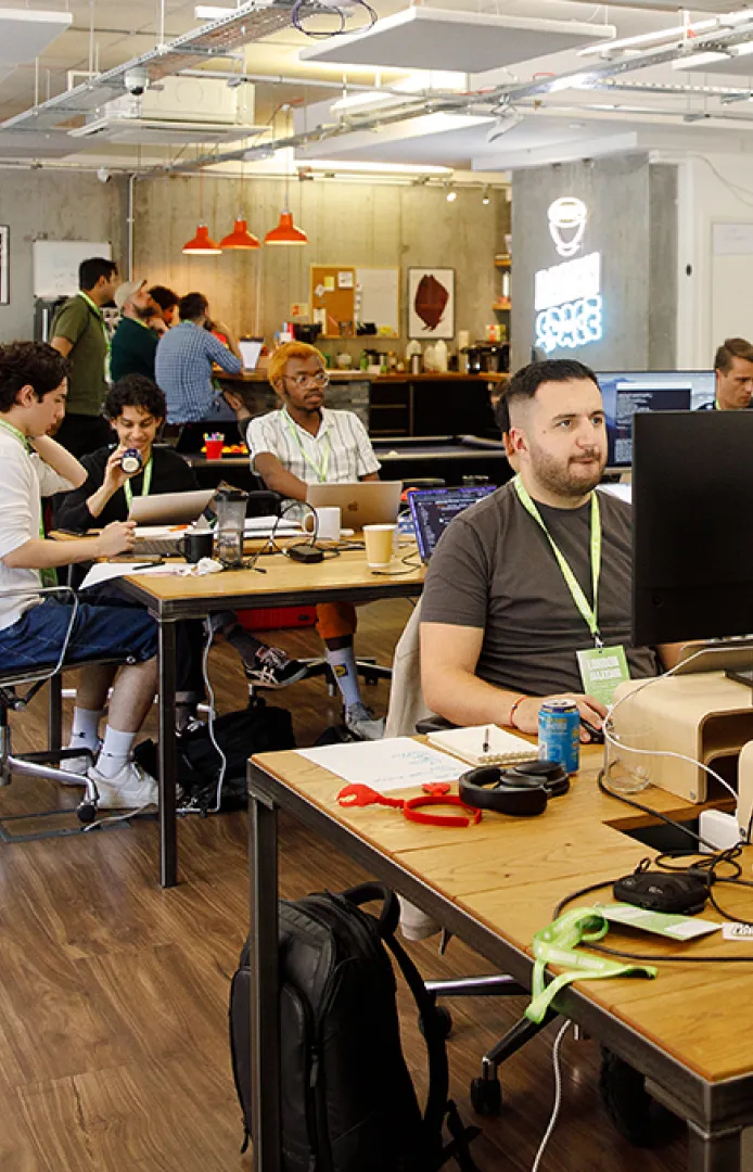 Founder working at a 28-inch monitor at Ramen Space in Dalston