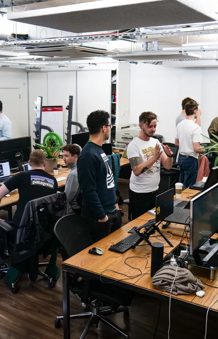 Founders working at desks with large monitors inside Ramen Space in Dalston