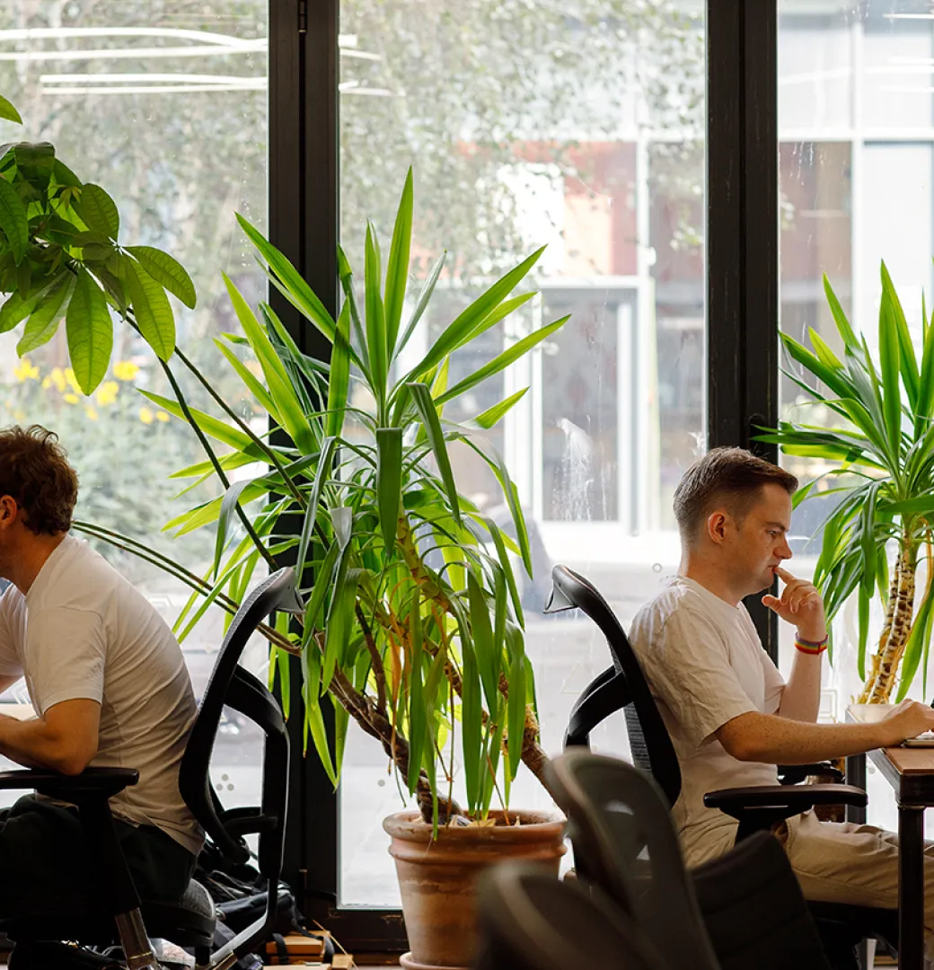 Founders working at large-monitor desks inside the Ramen Space coworking area in Dalston, East London