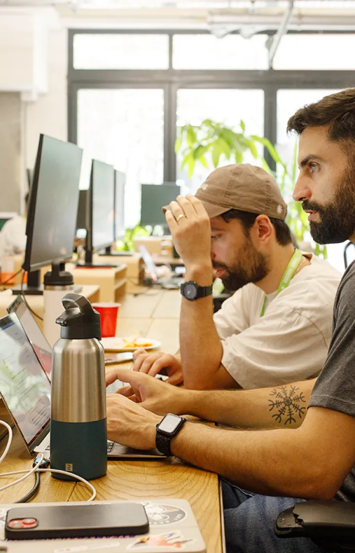 Startup founders working together in the open coworking area at Ramen Space in Dalston