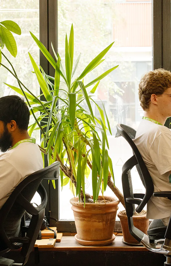 Founders working at desks with large monitors inside Ramen Space coworking in Dalston, East London